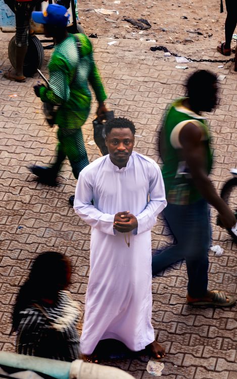 Man in Traditional Attire on Busy Street · Free Stock Photo