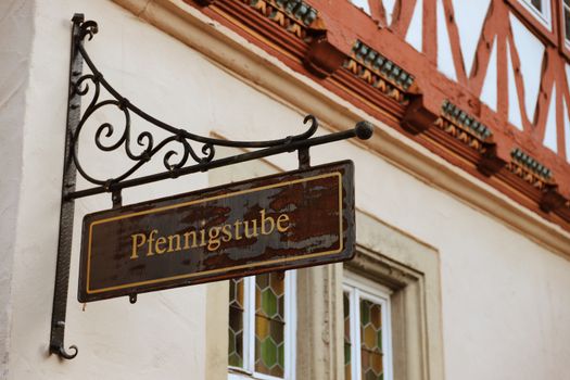 Vintage Pfennigstube sign on a timbered house in Bad Sooden-Allendorf, Germany.