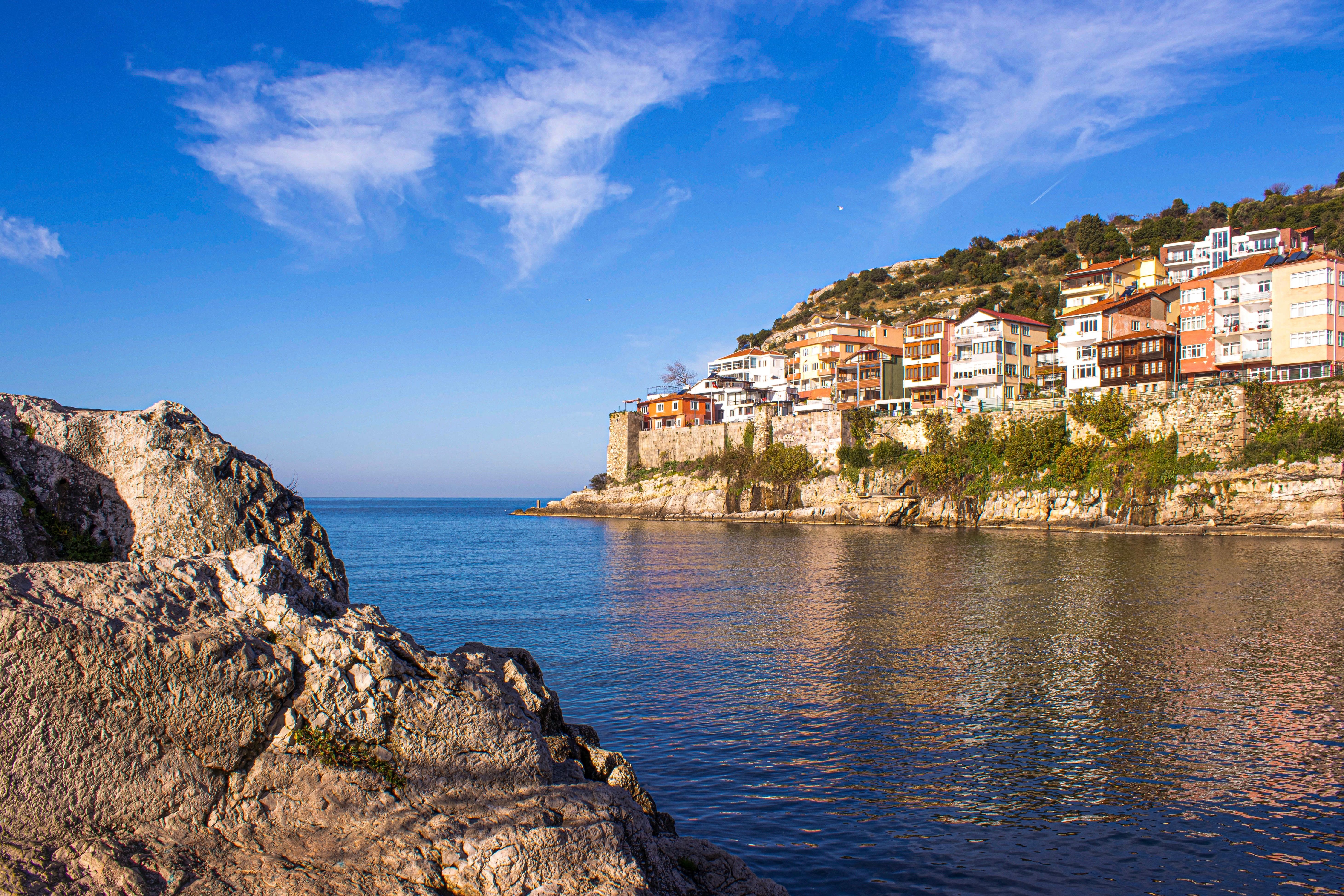 Beautiful coastal scene featuring colorful houses on a hillside by the water.