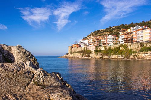 Free Beautiful coastal scene featuring colorful houses on a hillside by the water. Stock Photo