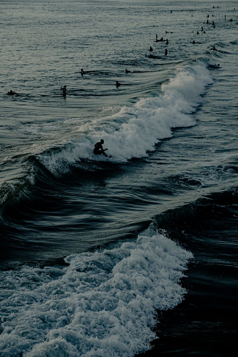 Surfers waiting on the line-up at dusk — Wendy Wei on Pexels