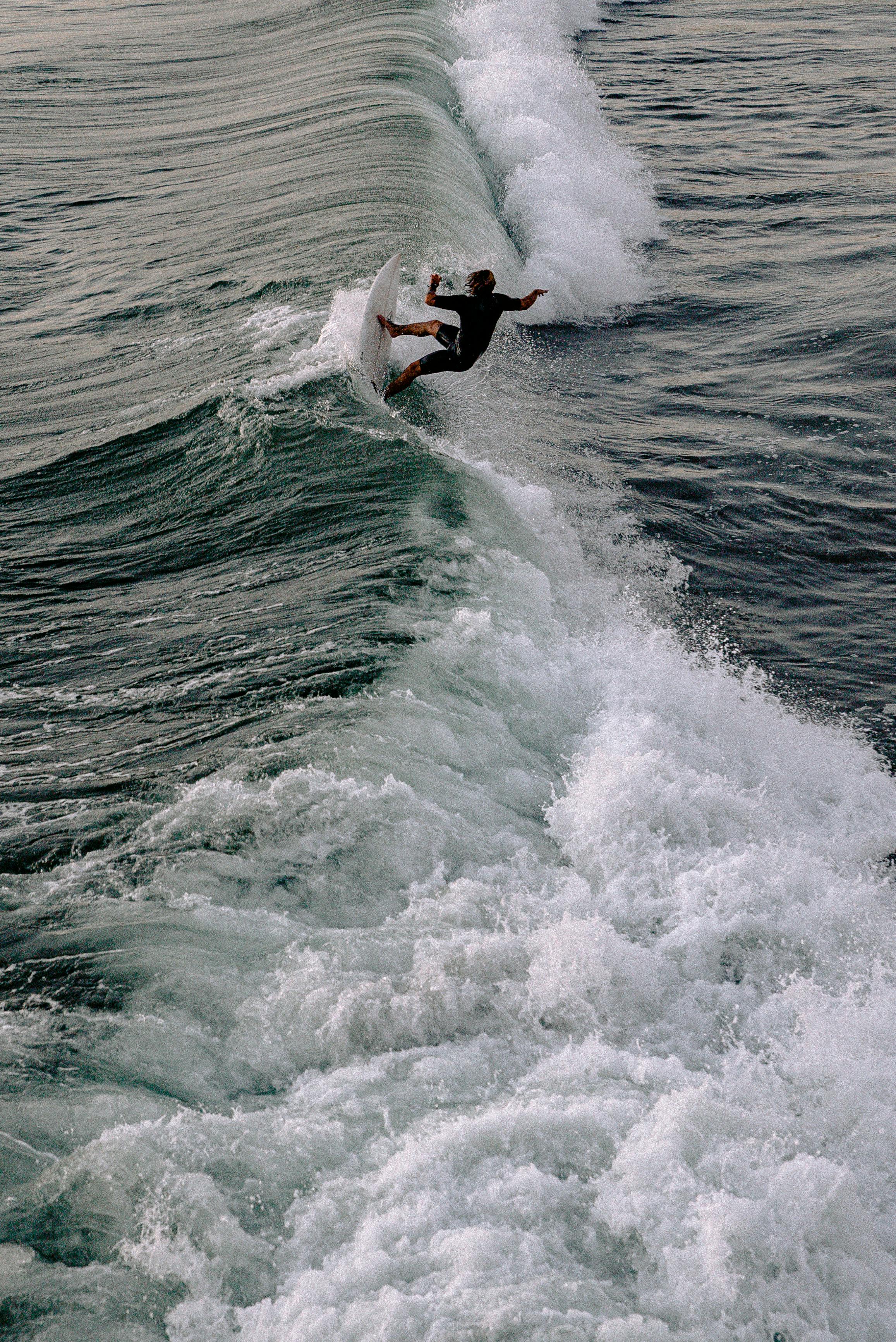 photo of person surfing on the sea