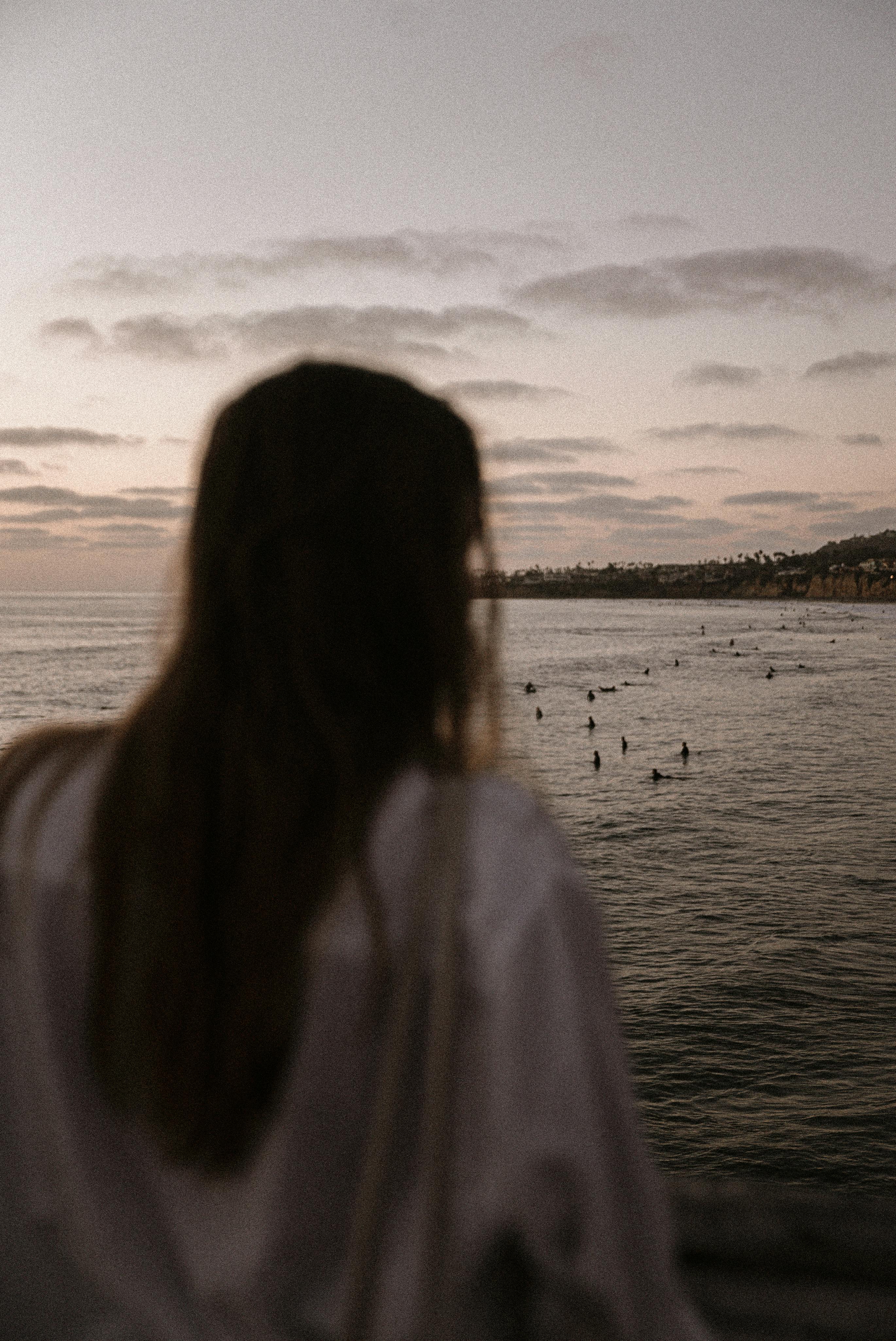 woman standing beside beach