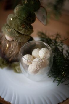Cozy winter scene with rustic holiday decor and coconut sweets.