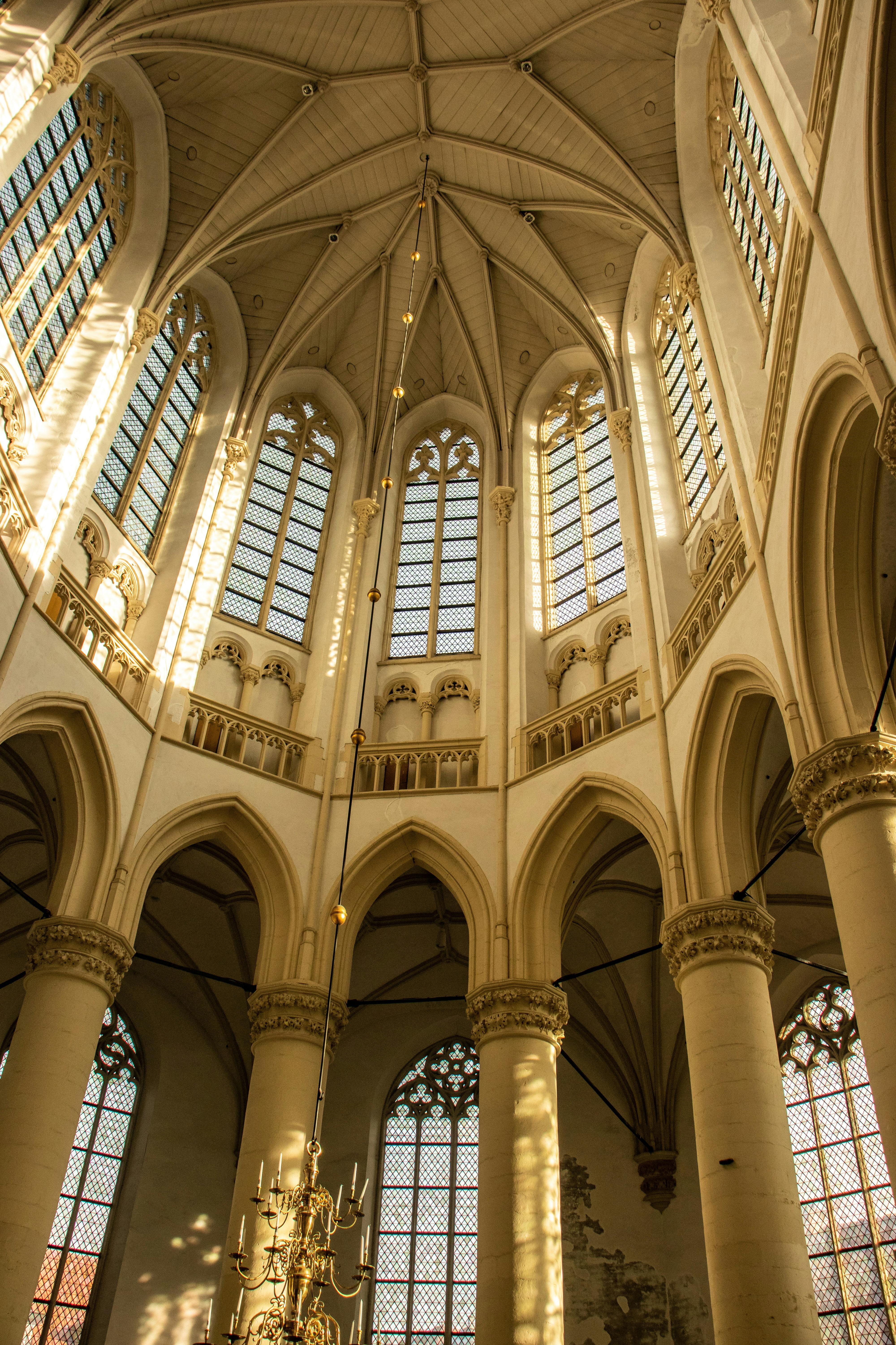 Majestic interior of Hooglandse Kerk, Leiden showcasing Gothic architecture and sunlight.