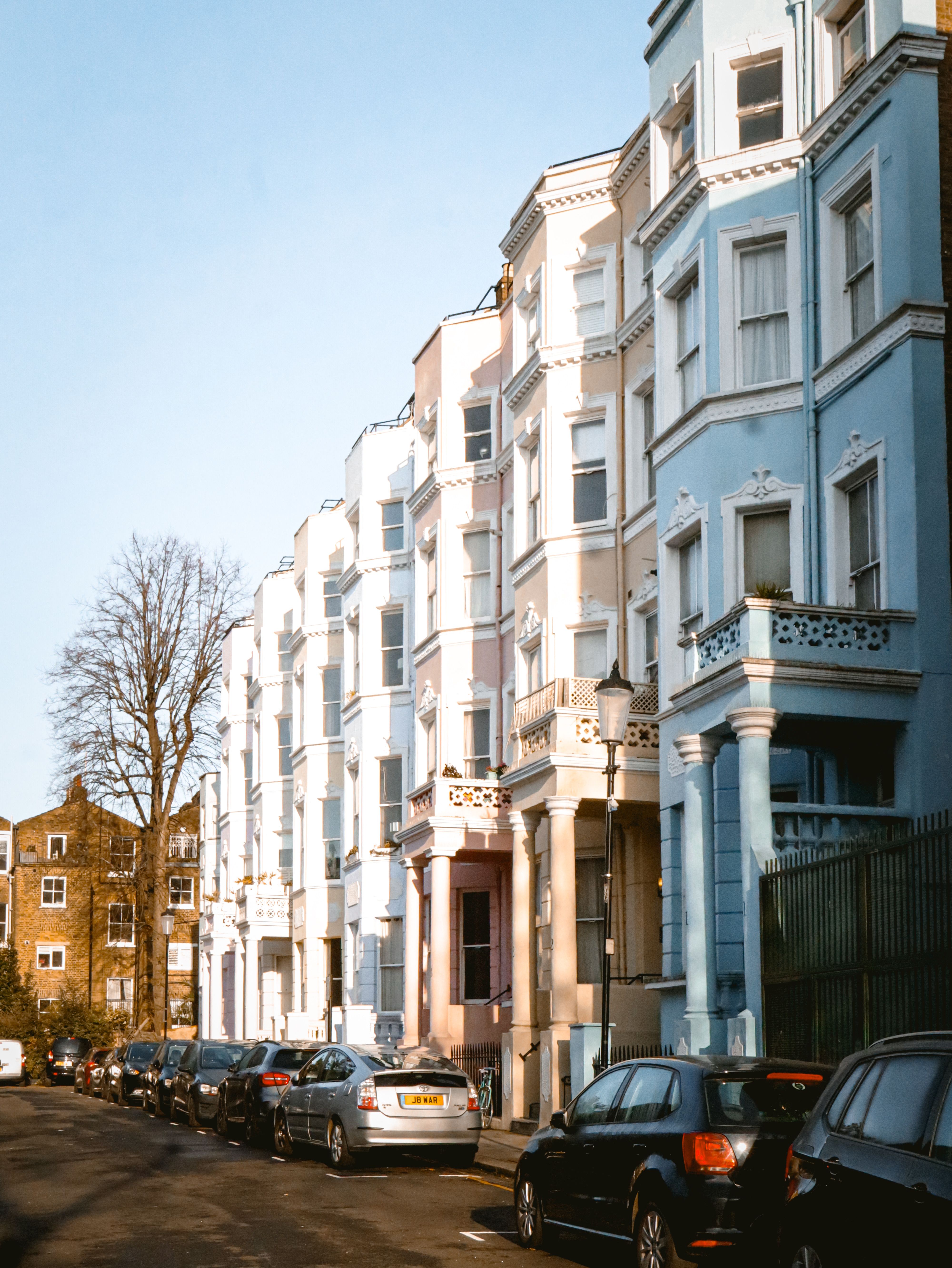 Free Vibrant pastel-colored row houses in Notting Hill, London capture the essence of urban charm. Stock Photo