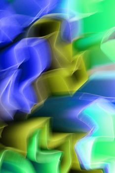 Blurred abstract lights creating vibrant patterns in blue, green, and yellow.