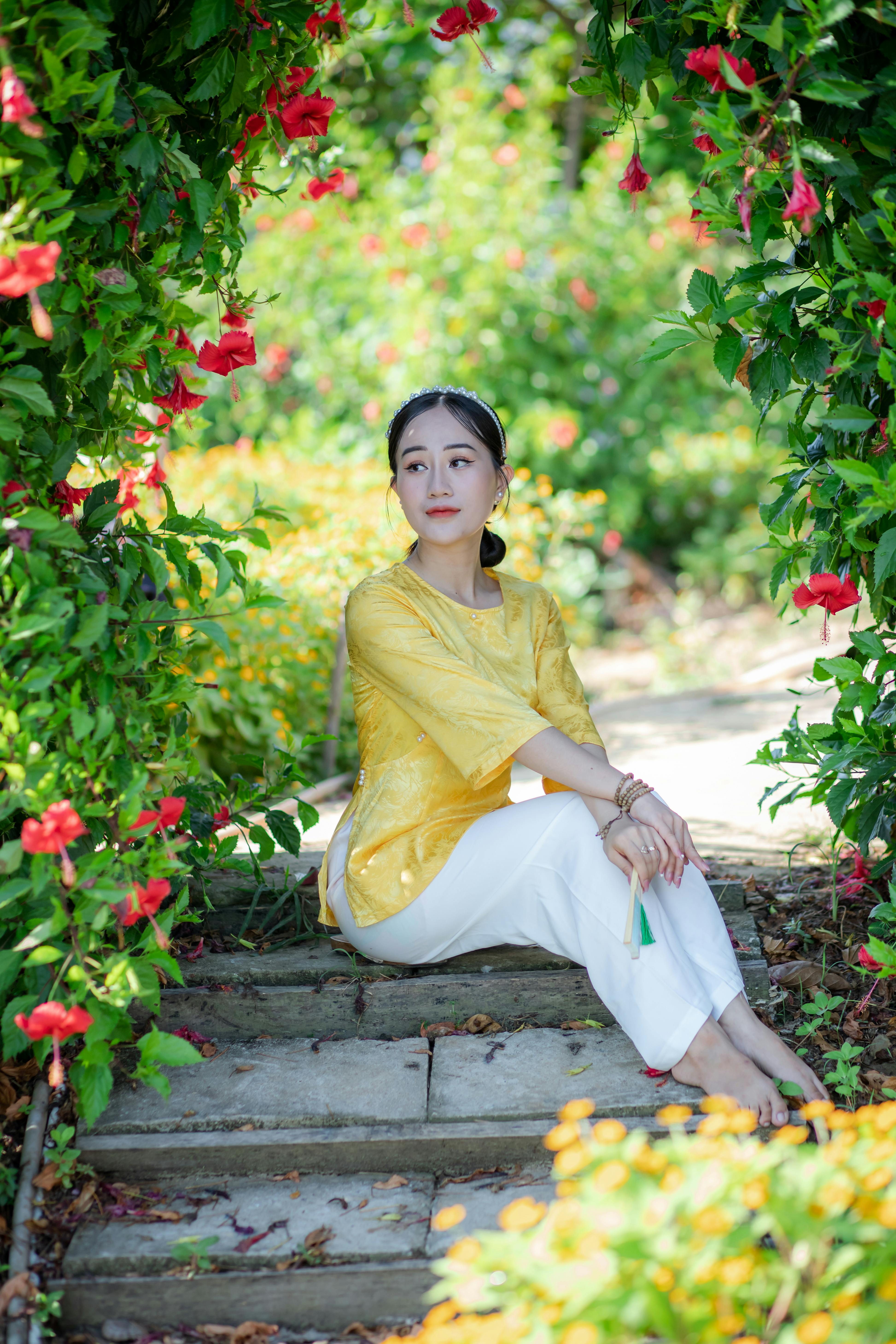 woman in traditional vietnamese attire in lush garden