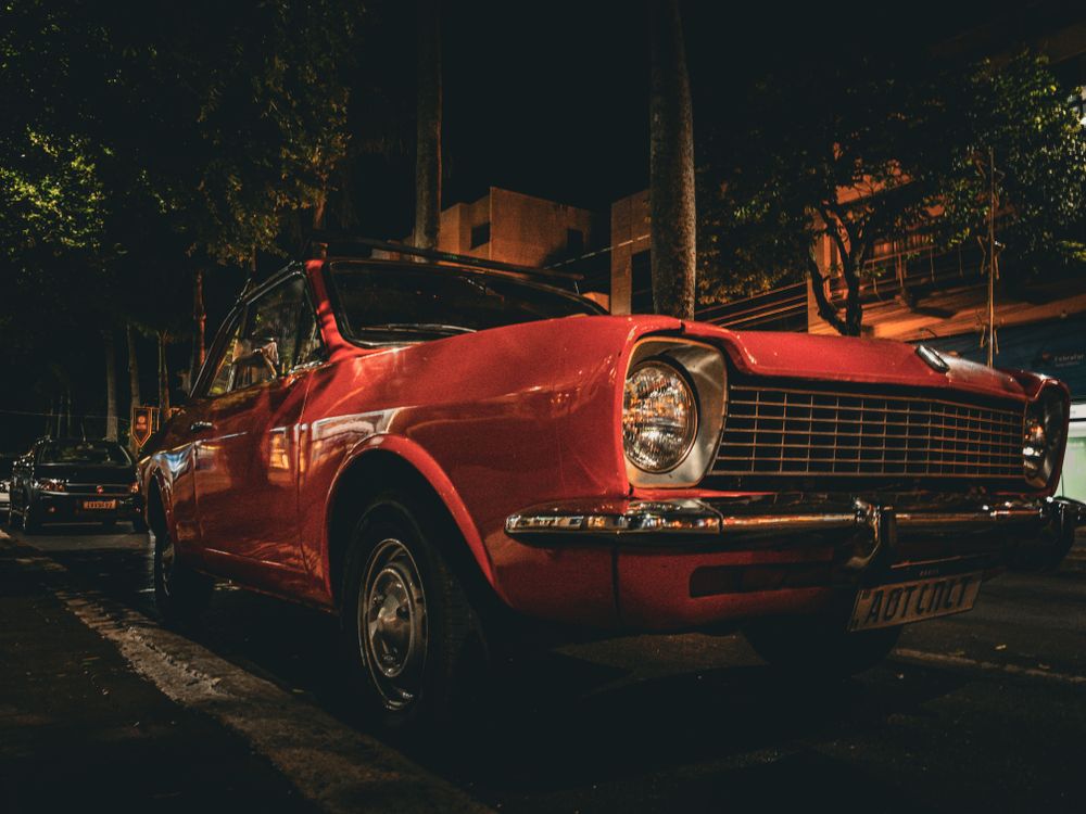 Classic Red Vintage Car on Night City Street · Free Stock Photo