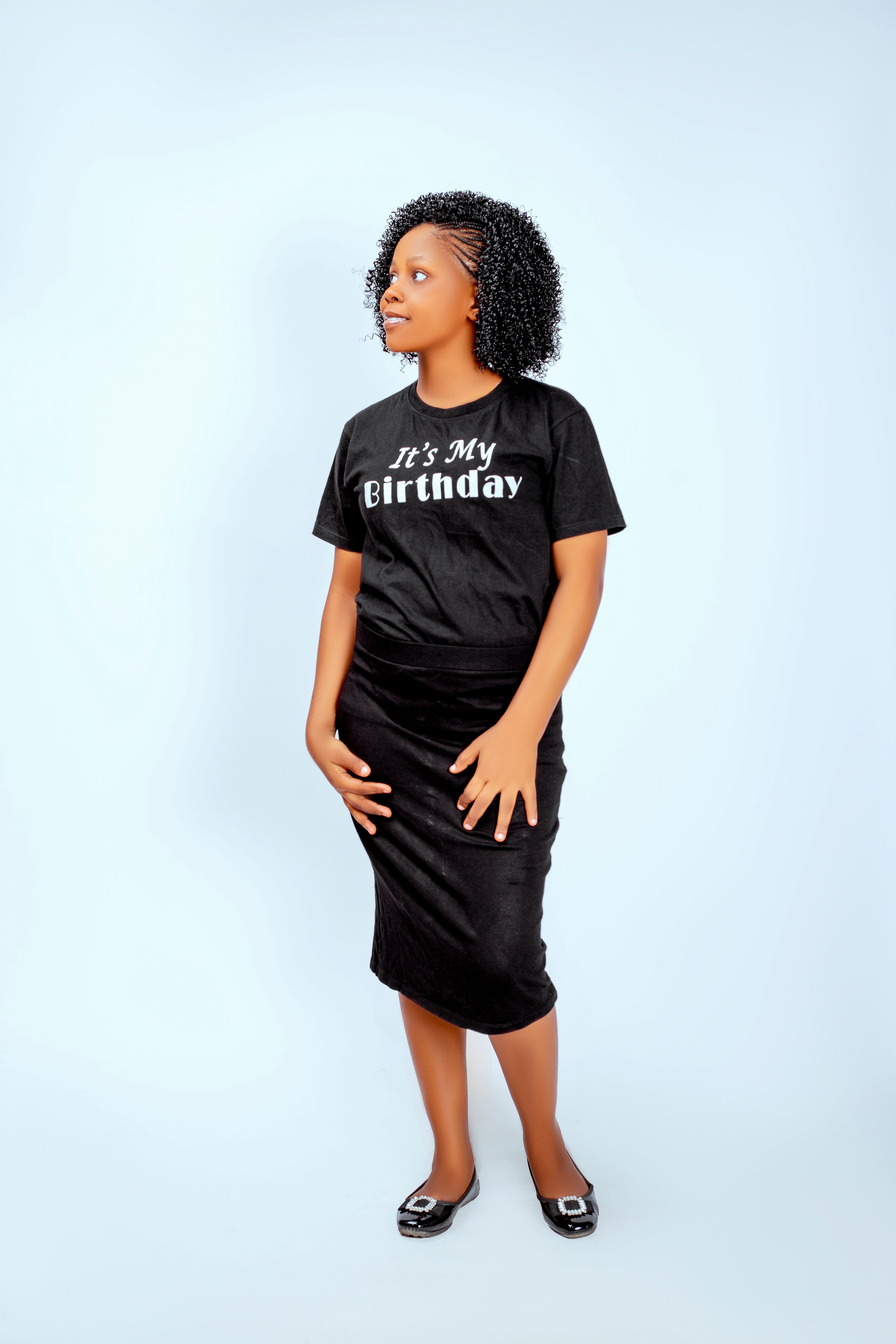Young woman celebrates her birthday in style with a themed shirt.