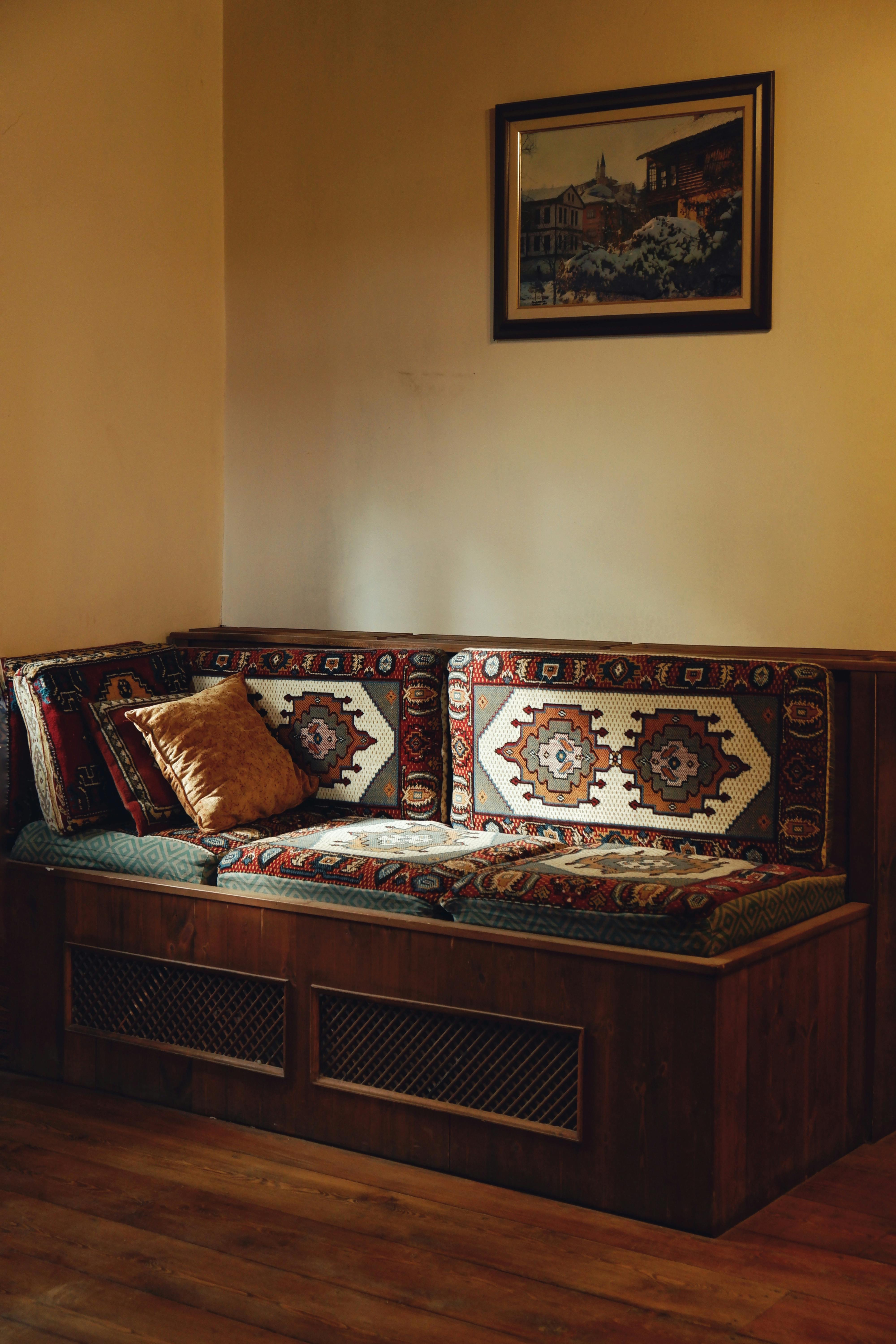 Warm, inviting corner with a vintage patterned couch ideal for relaxation.