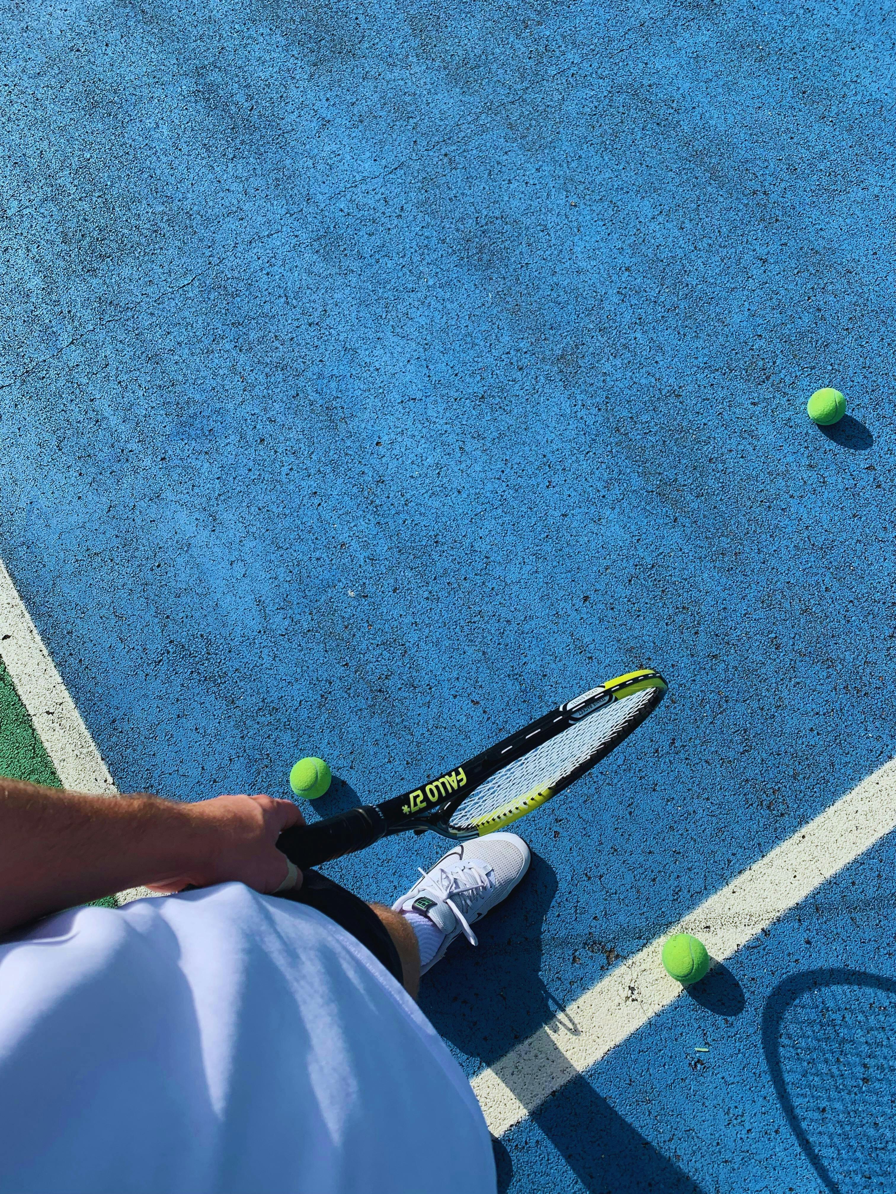 tennis player on blue court preparing for serve