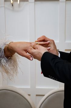 Close-up of a couple exchanging rings during a wedding ceremony.