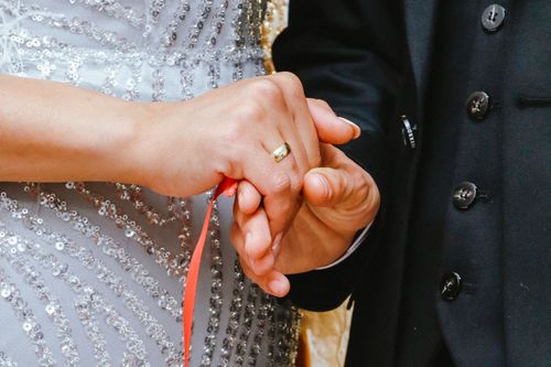 Free Close-up of a couple's handbinding ritual, symbolizing unity in marriage. Stock Photo