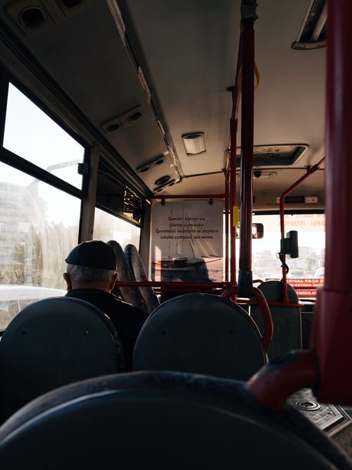 Free A thoughtful scene inside a public city bus with an older man by the window. Stock Photo