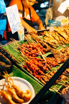 Discover vibrant Thai street food skewers at a busy Chiang Mai market stall.
