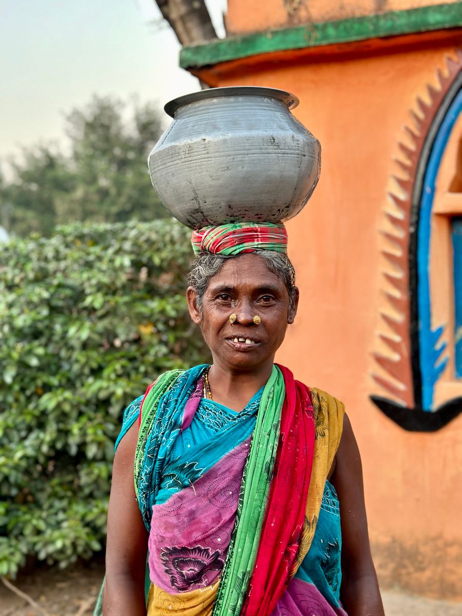 An Indian woman balancing a water pot outdoors