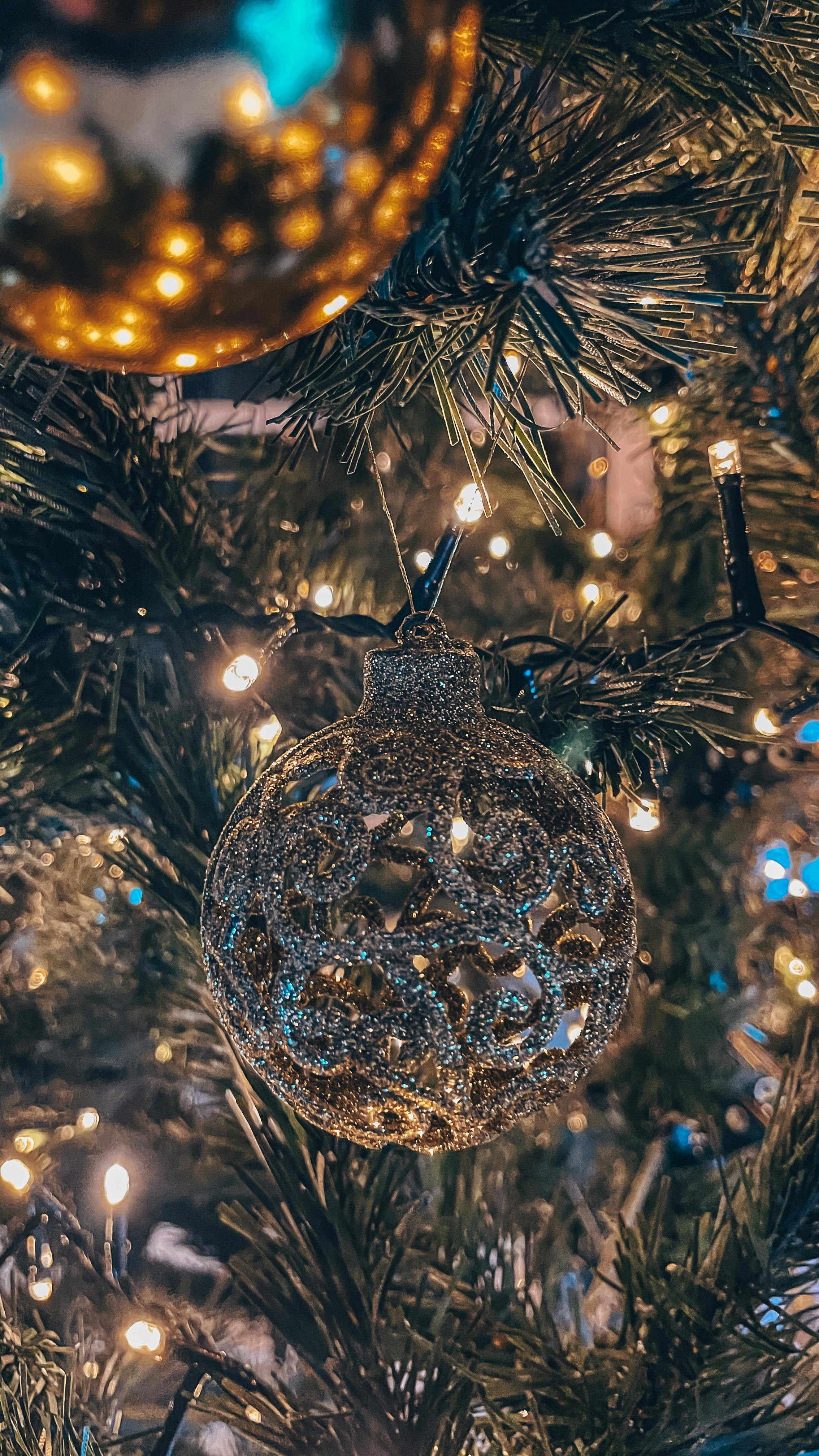 glittering christmas ornament on pine branch