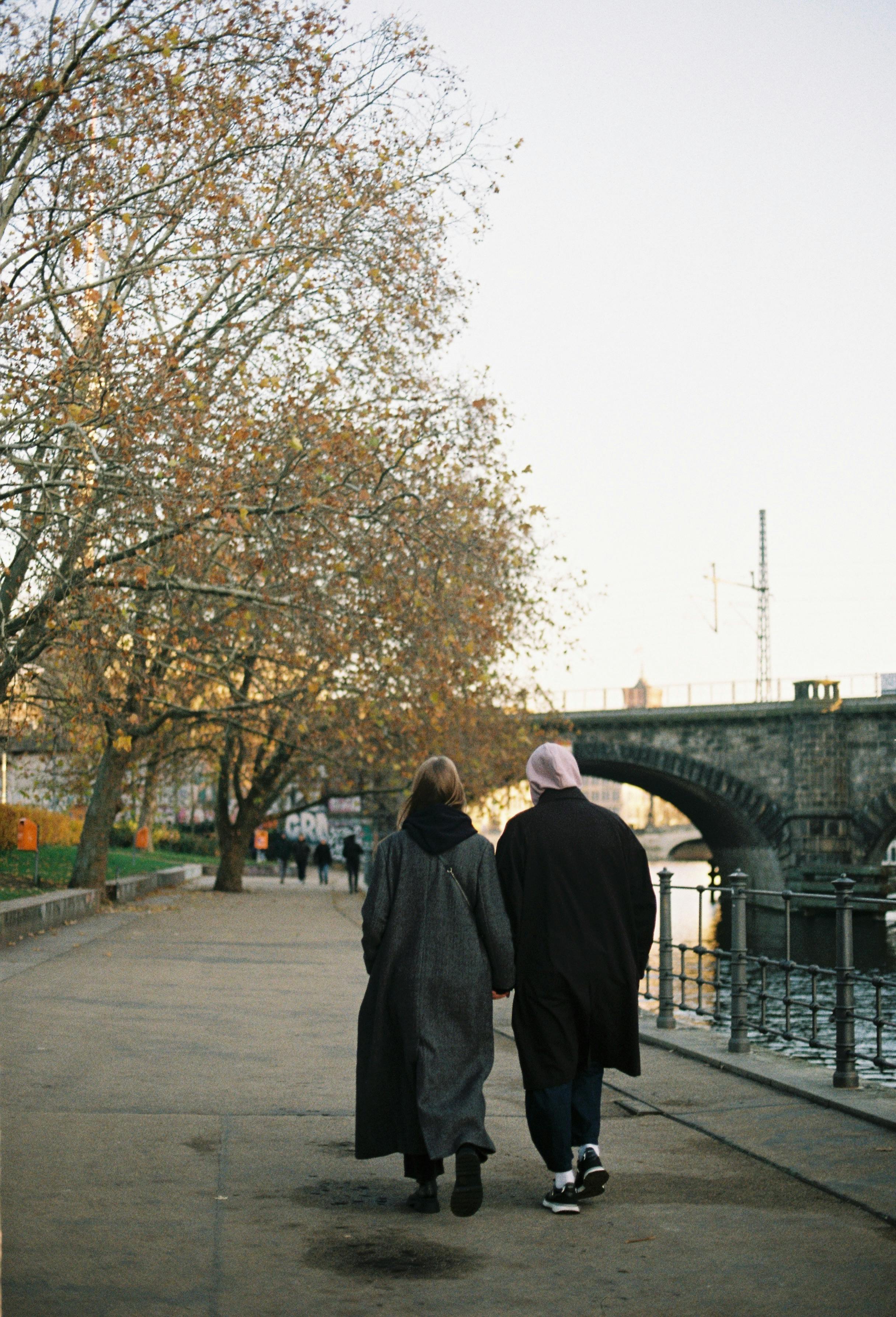 romantic stroll along autumn riverside pathway