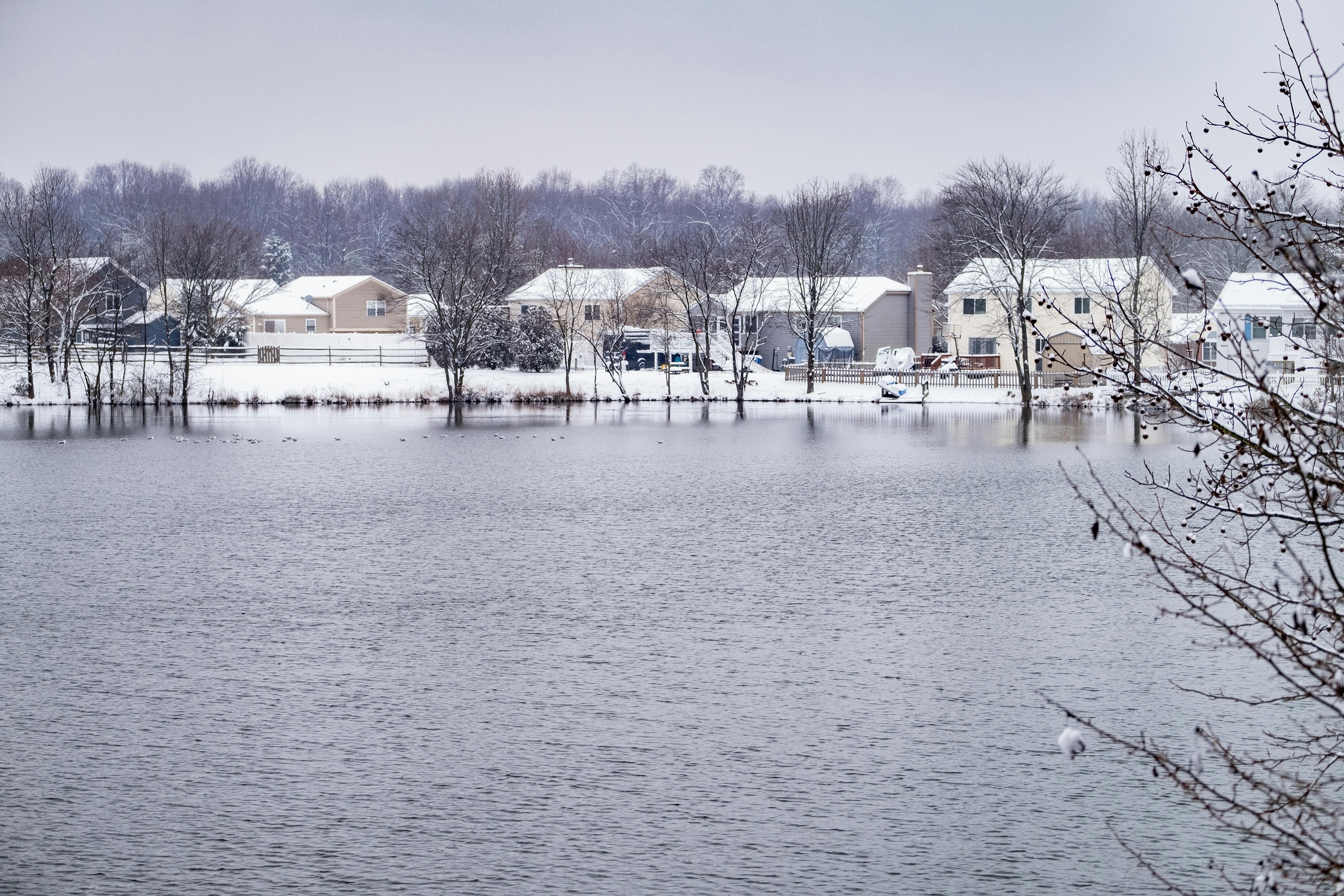 snow covered suburban pond in maryland