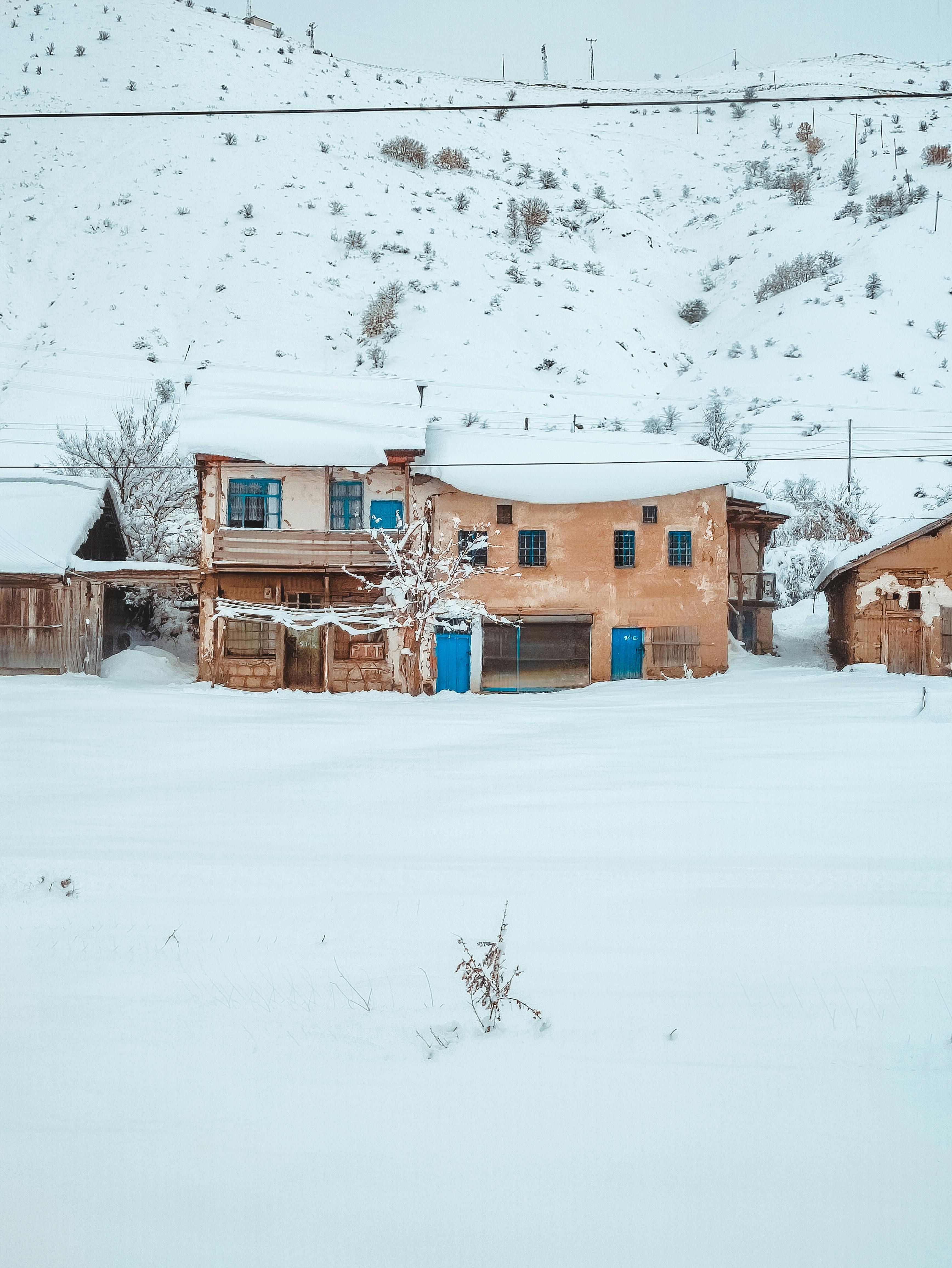 snow covered rustic house in winter landscape