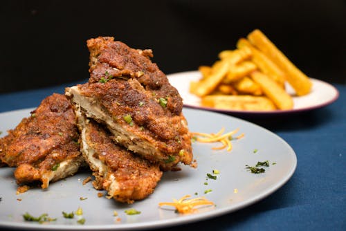 Plates with deep fried meat and french fries