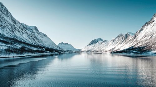 Free Breathtaking view of snow-covered mountains and serene fjord in Northern Norway. Stock Photo