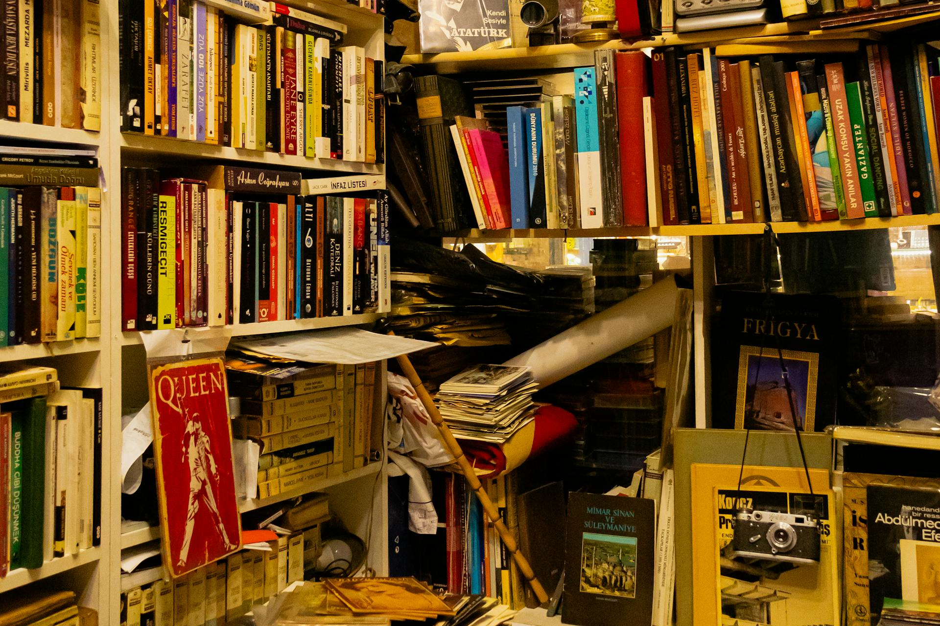 A richly stacked bookshelf inside a vintage bookstore in Istanbul, capturing the charm of old books and eclectic decor.