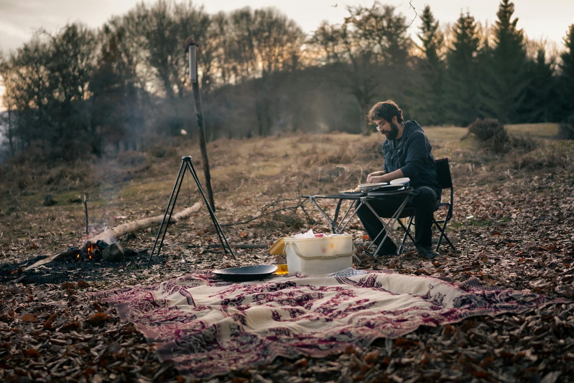 A man camping at the forest in autumn alone