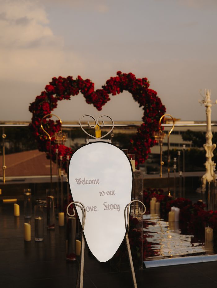 Heart-shaped floral arch with candles