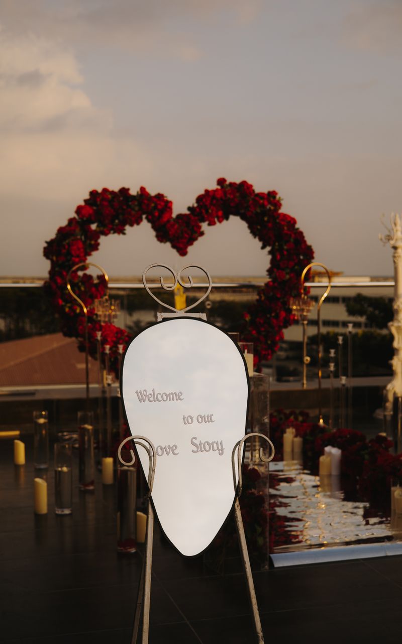 Heart-shaped floral arch with candles