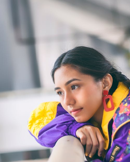Woman In Purple And Yellow Jacket Facing Sideways