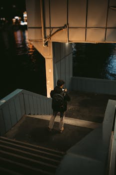 A lone photographer capturing moments on a dimly lit staircase in İstanbul.