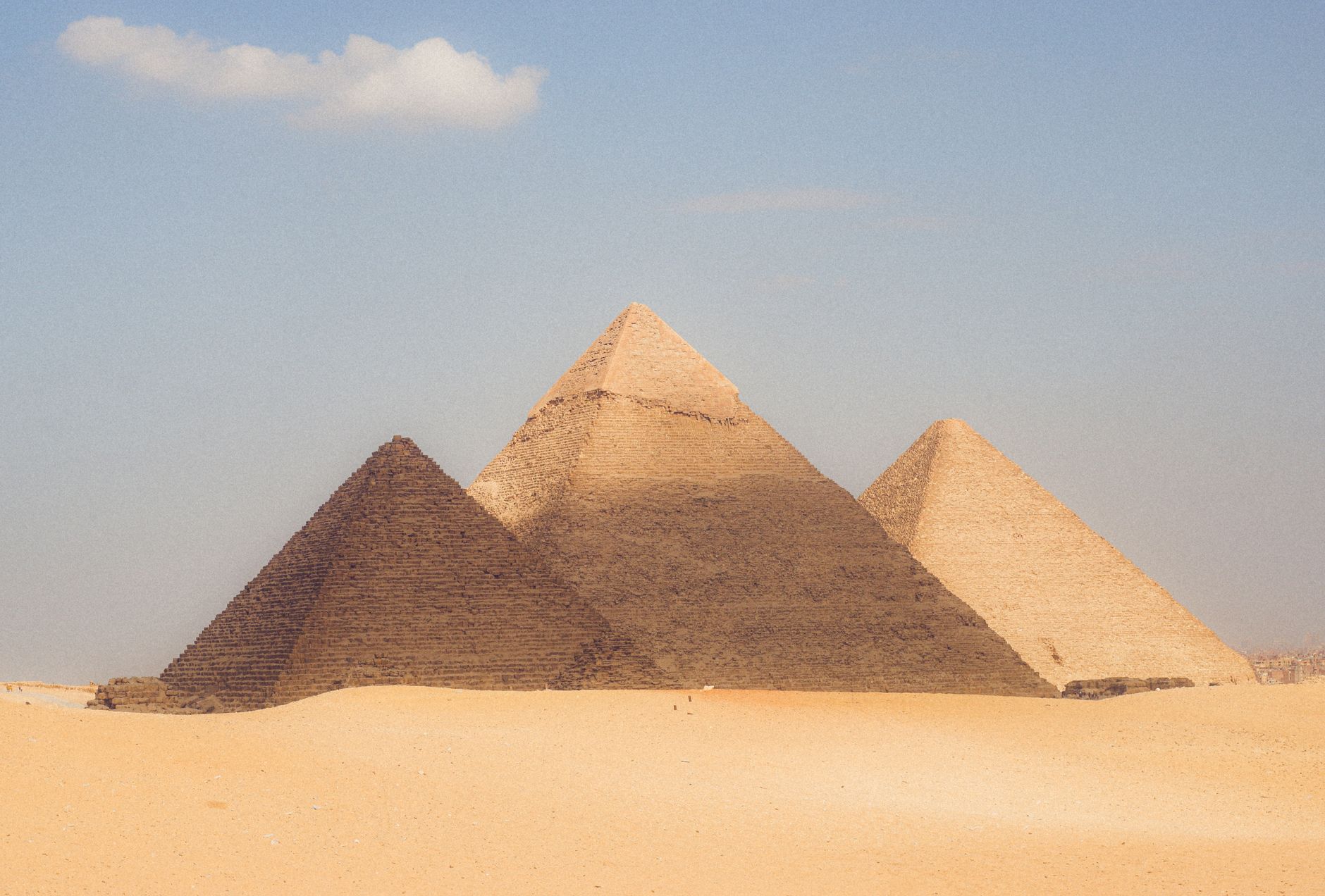 A stunning view of the Pyramids of Giza, showcasing their grandeur against a clear sky.