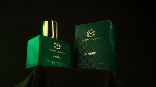 Free The Man Company Ombre fragrance bottle and box displayed elegantly against a dark background. Stock Photo