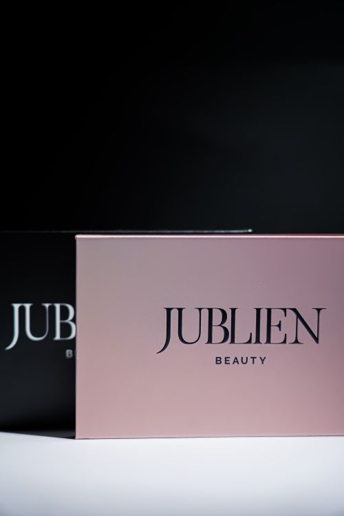 Free Minimalist presentation of Jublien Beauty packaging in contrasting colors. Stock Photo