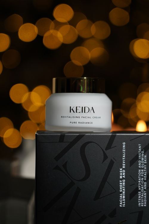 Free High-end facial cream against a warm, bokeh background, highlighting luxury. Stock Photo