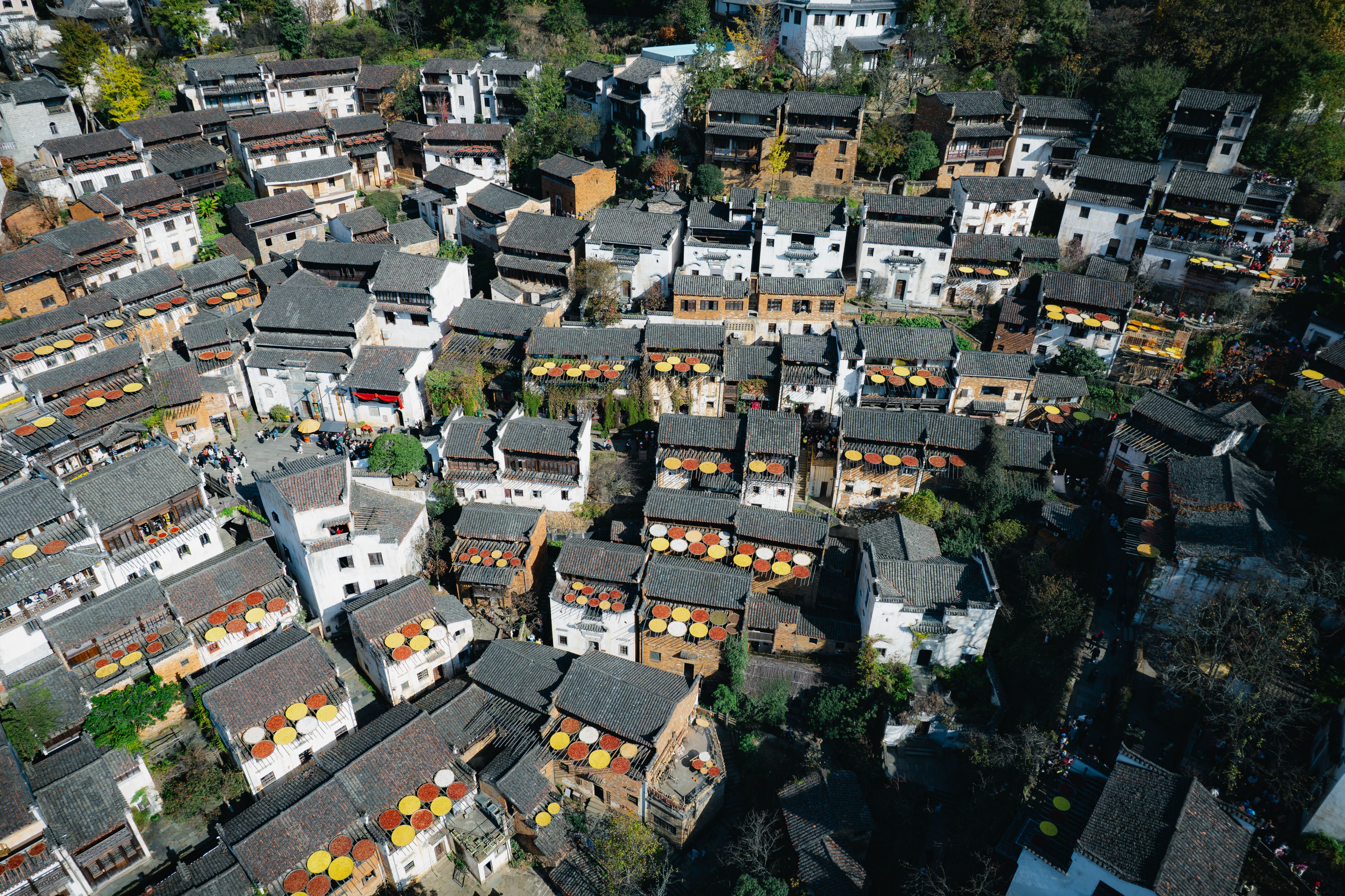 Breathtaking 1 Day Yangshuo Adventure Balloon Helicopter and Cave Experience Review 2026 - Aerial view of Huangling Village in China showcasing traditional rooftops and vibrant autumn colors.