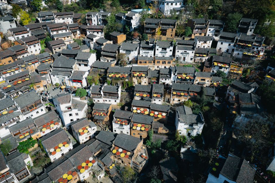 Breathtaking 1 Day Yangshuo Adventure Balloon Helicopter and Cave Experience Review 2026 - Aerial view of Huangling Village in China showcasing traditional rooftops and vibrant autumn colors.