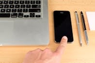 Space Gray Iphone Beside Macbook