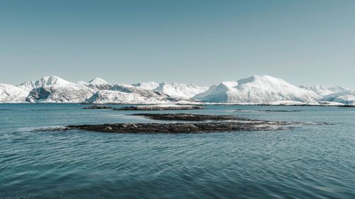 Free Breathtaking view of snow-capped mountains and calm waters in Arctic Norway. Stock Photo