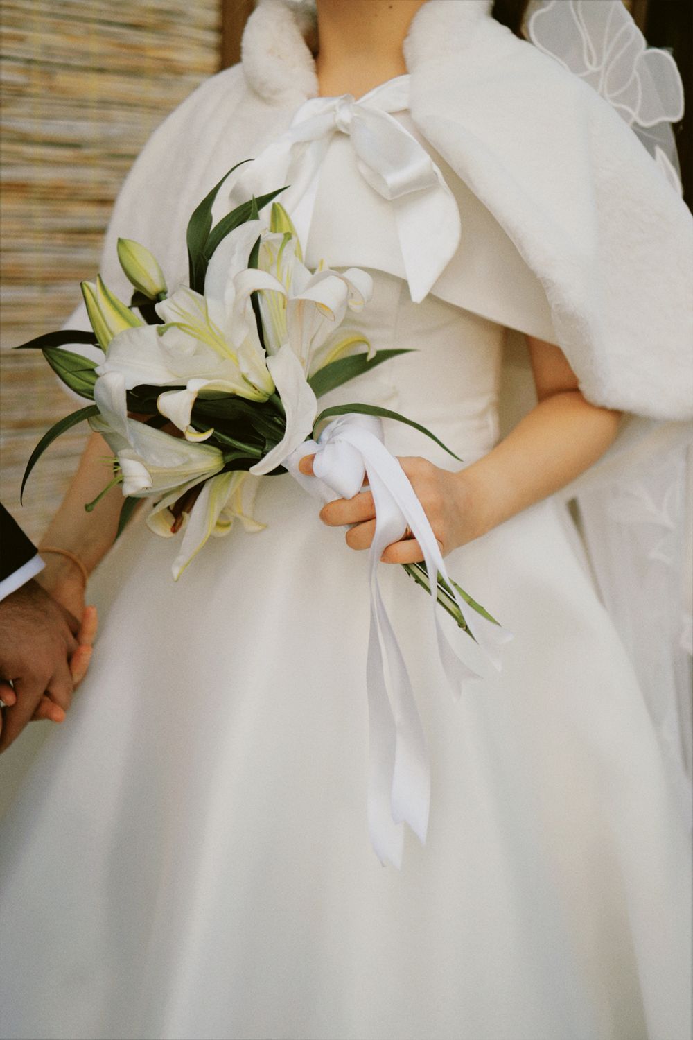 Elegant bride holding lilies