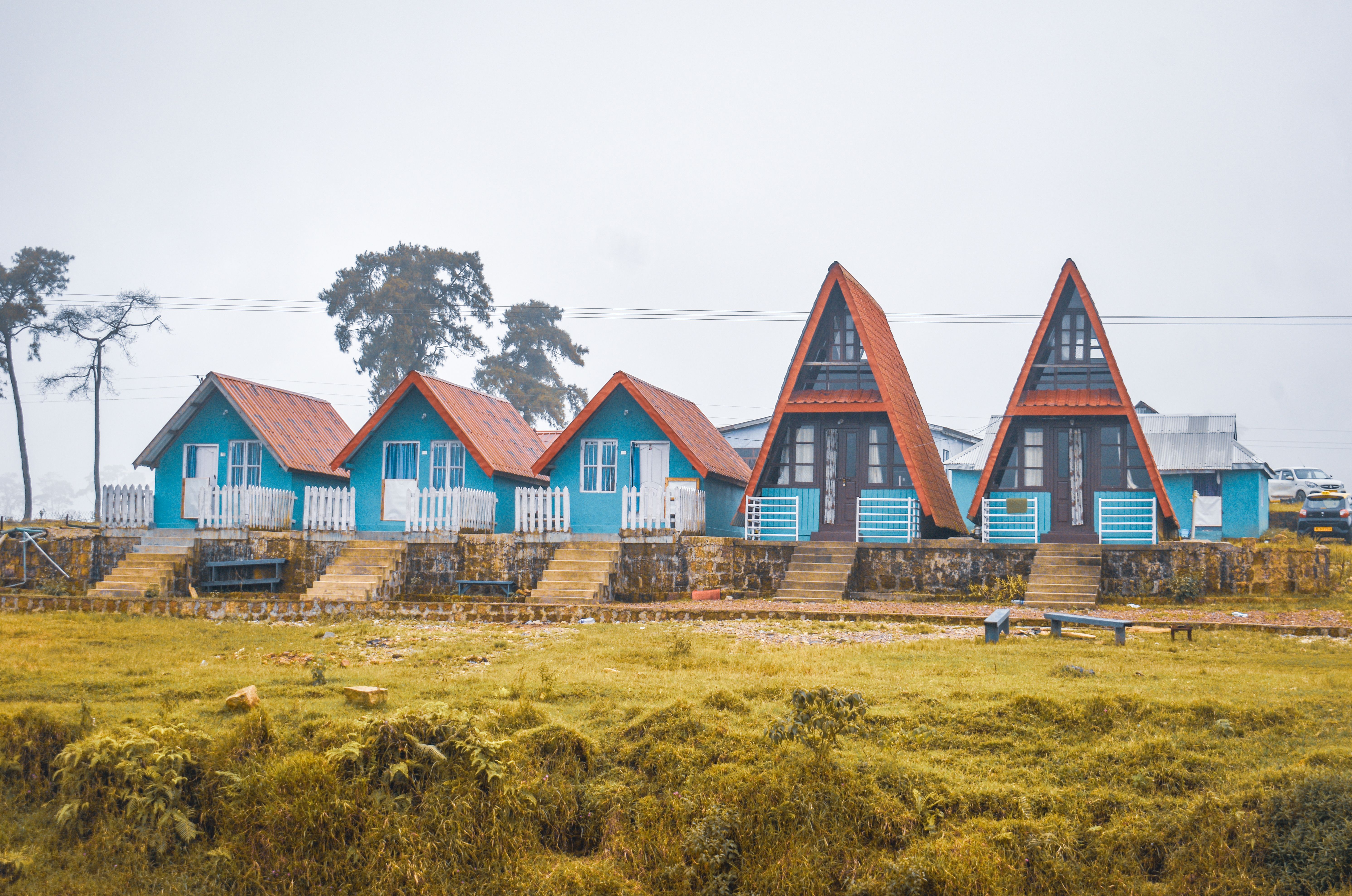 Charming A-frame and cottage style houses amidst Meghalaya's serene landscape.