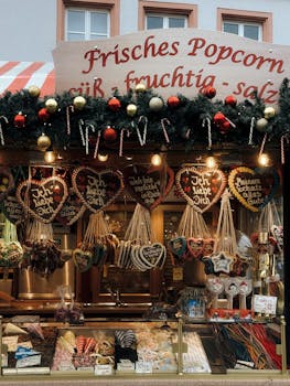 Festive Christmas market stall in Bayreuth, Germany featuring traditional gingerbread hearts and confectionery.