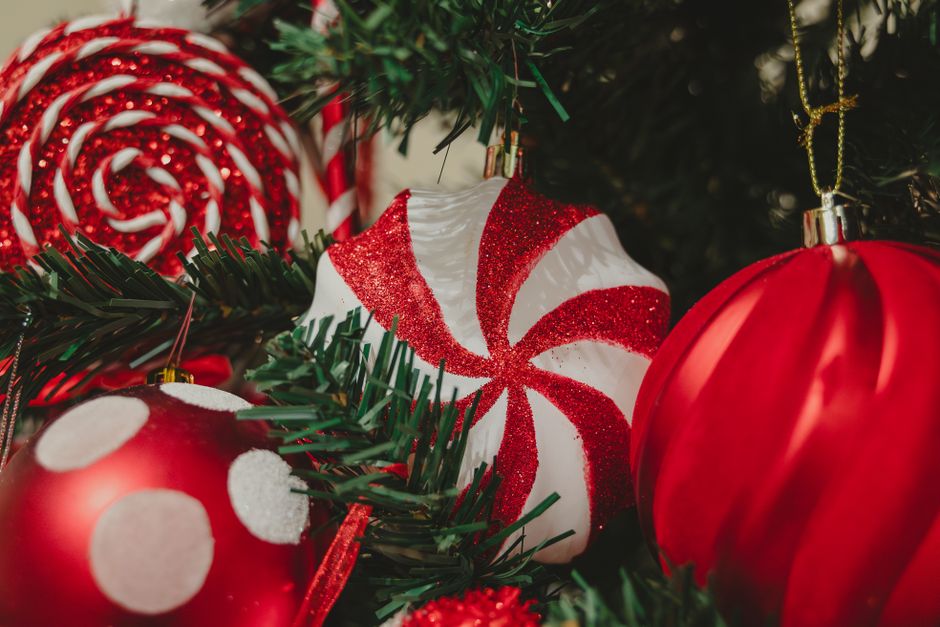 Close-up of colorful Christmas ornaments on a holiday tree, creating a festive atmosphere.