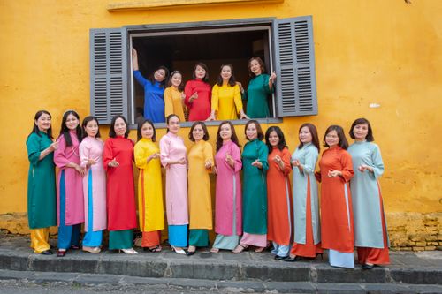 Free Colorful group portrait of women in traditional Ao Dai in Hội An, Vietnam. Stock Photo