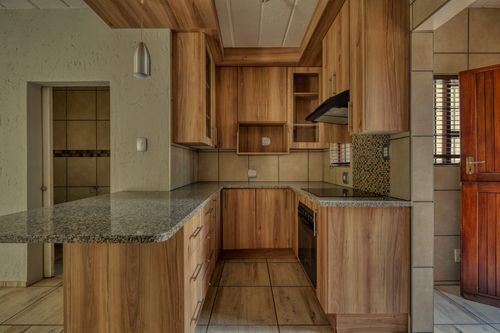 Free Elegant modern kitchen with wooden cabinetry and granite countertops. Stock Photo