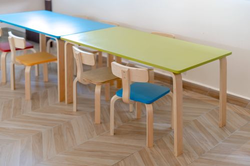 Free Vibrant child-sized chairs and tables in an educational setting. Stock Photo