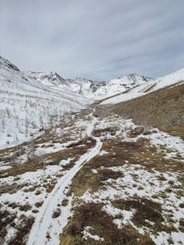 A breathtaking drone aerial view of snowy mountains and valleys in Nevada.