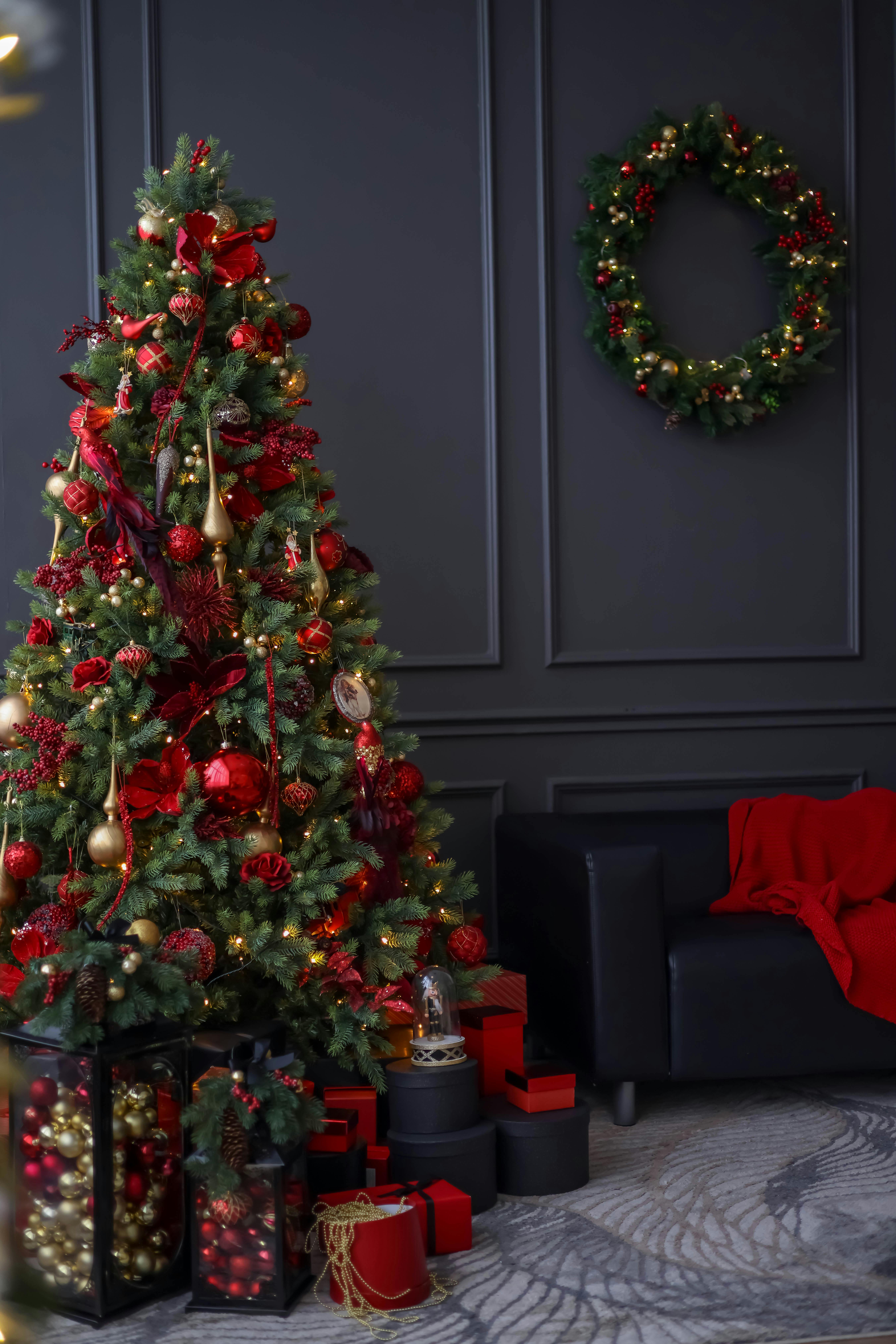 Festive living room with a beautifully decorated Christmas tree and presents.